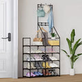 Double-row coat and shoe rack by a front door with coats, bags and shoes