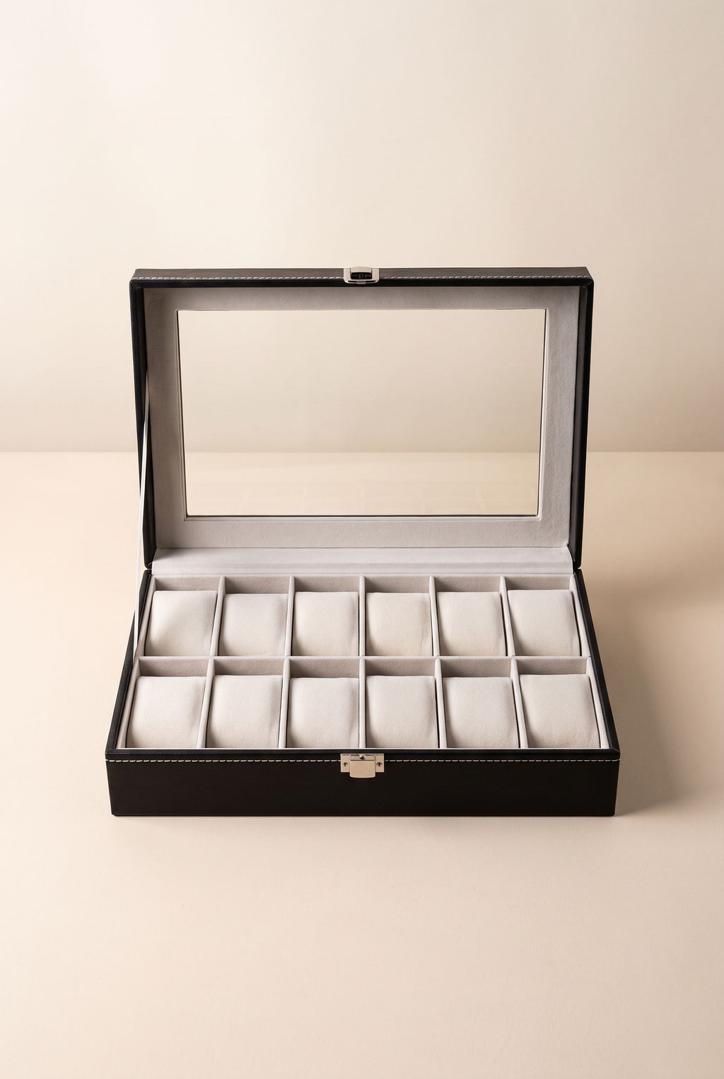 Black 12-slot watch display case with window lid open, 12 cushions in two rows, empty