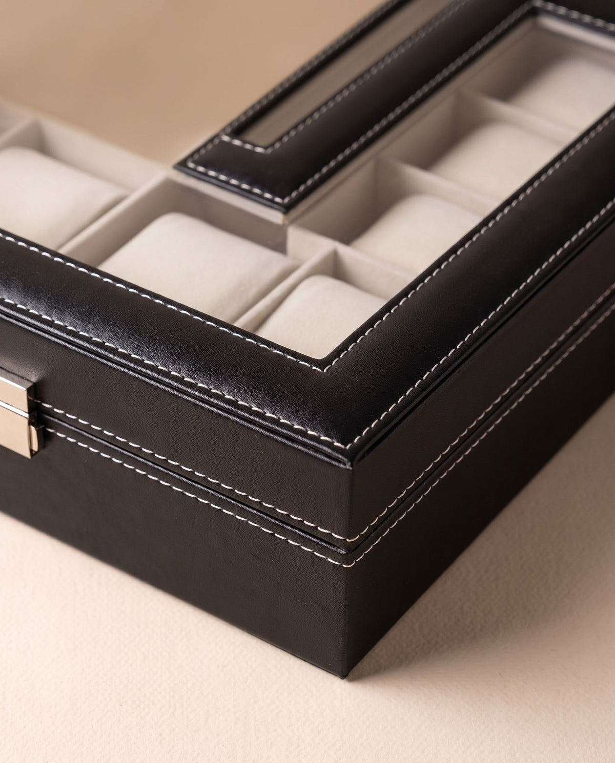 Close detail of the watch case corner, white contrast stitching and cushions