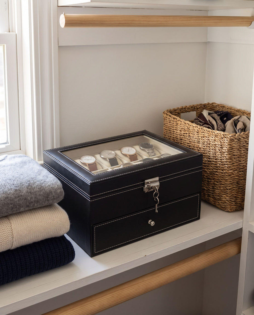 Two-tier watch box closed with key in the lock on a closet shelf (watches not included)