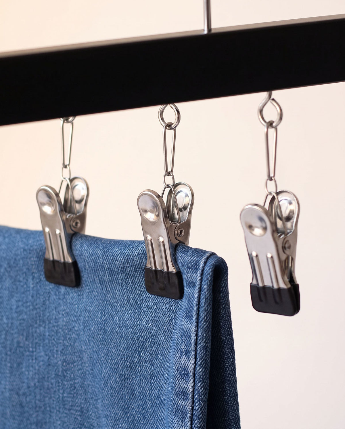 Close detail of the FlexClip spring clips gripping a pair of jeans (jeans not included)
