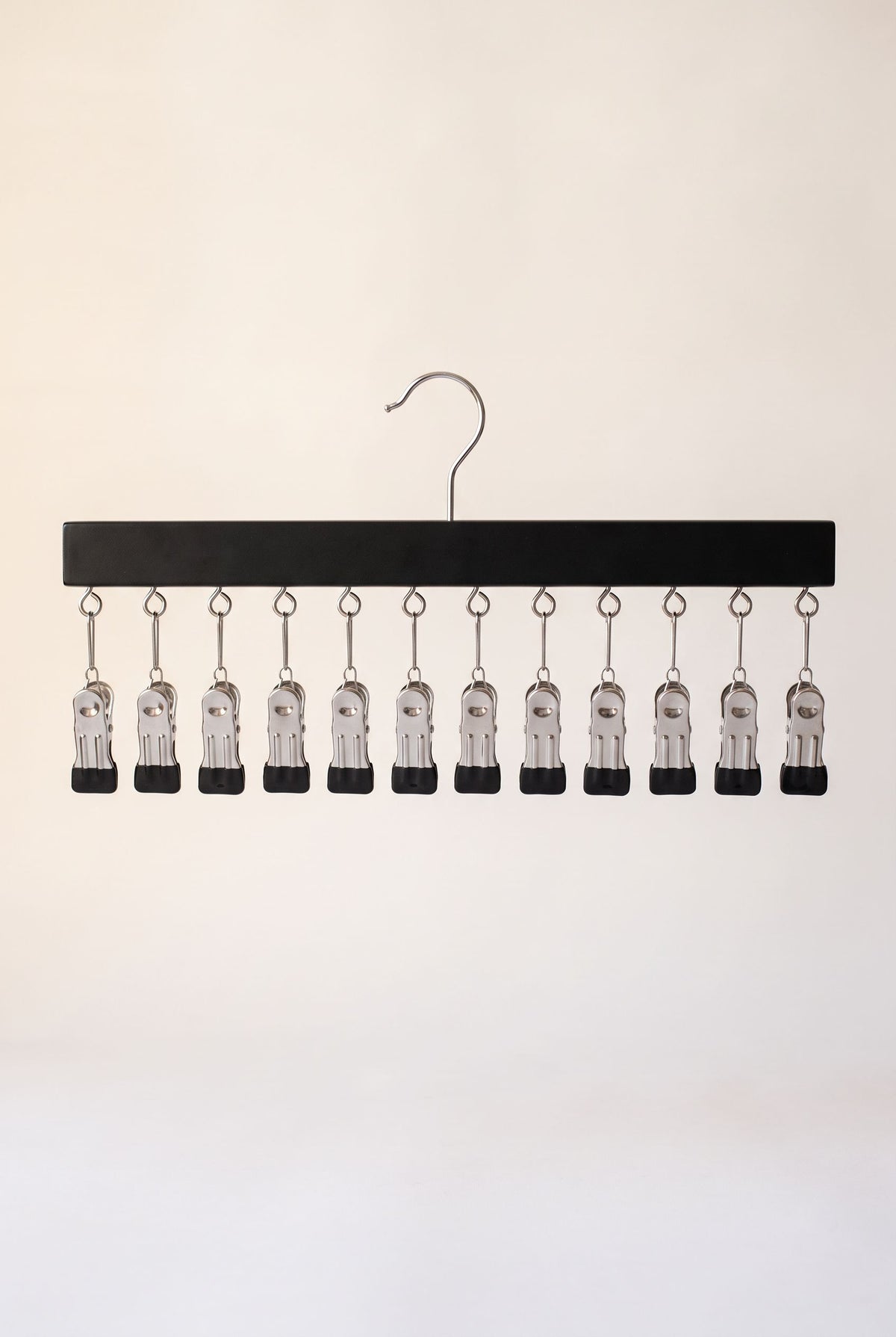 Black FlexClip closet organizer with 12 clips on one bar and a swivel hook, empty