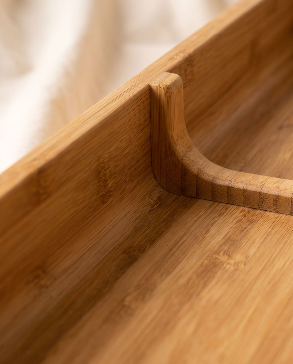 Close detail of a bamboo compartment corner showing one-piece construction