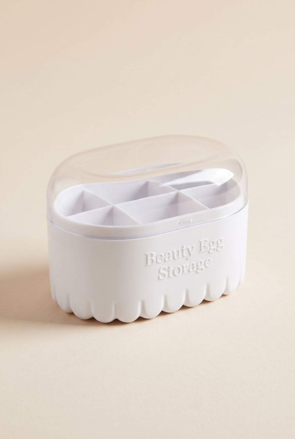 Beauty sponge storage box with white fluted base and clear domed lid, empty