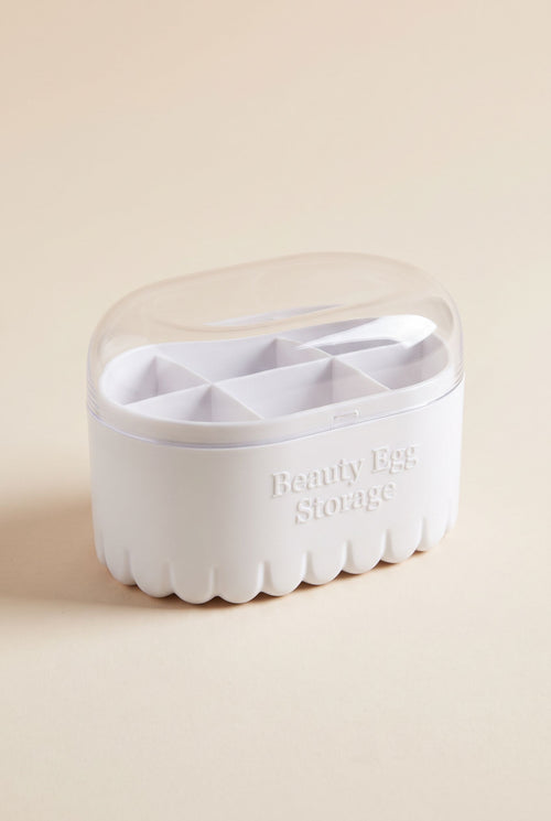 Beauty sponge storage box with white fluted base and clear domed lid, empty