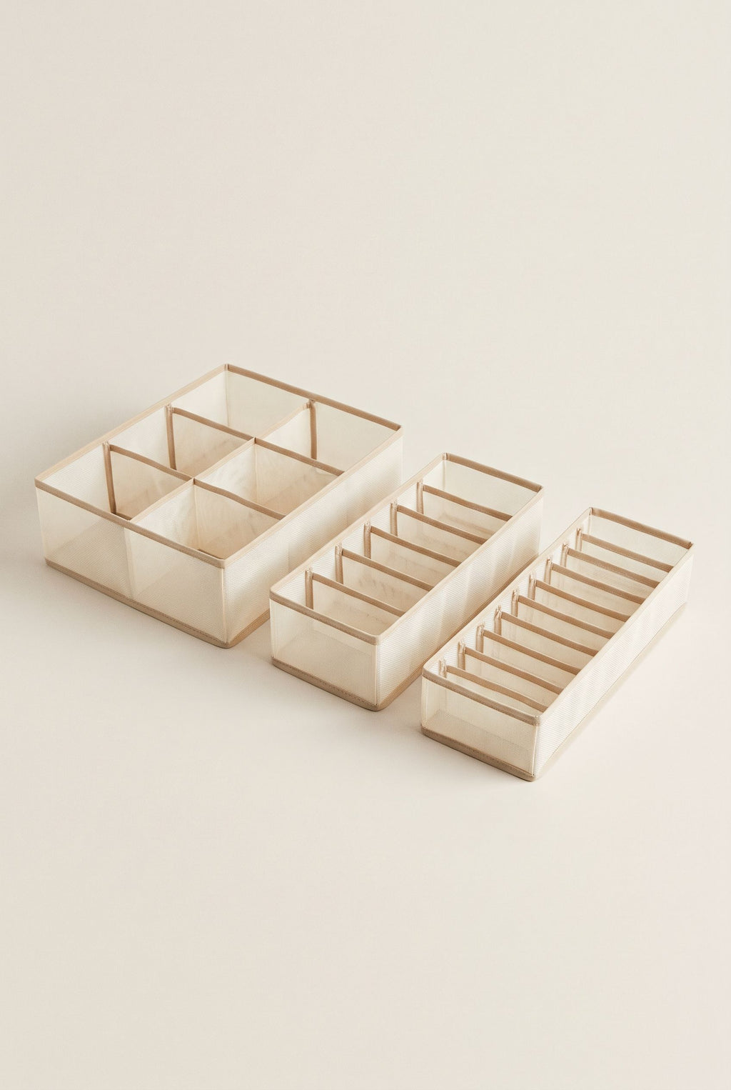 Beige three-piece drawer organizer set with 6, 7 and 11 compartments, empty