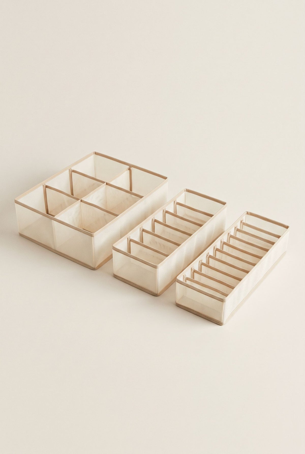 Beige three-piece drawer organizer set with 6, 7 and 11 compartments, empty